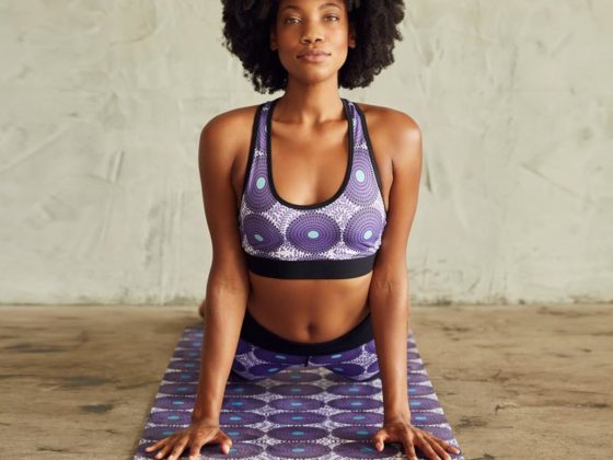 Woman working out joyfully at home during a faith-based workout session with worship music playing in the background
