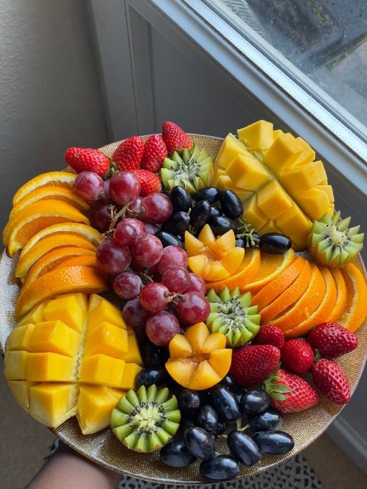 A colorful plate of fresh fruits, vegetables, and whole grains on a dining table, representing healthy eating and gratitude.