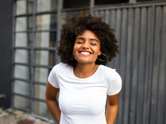 A radiant woman smiling confidently, exuding joy and peace
