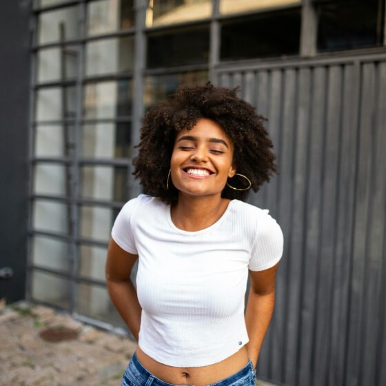 A radiant woman smiling confidently, exuding joy and peace