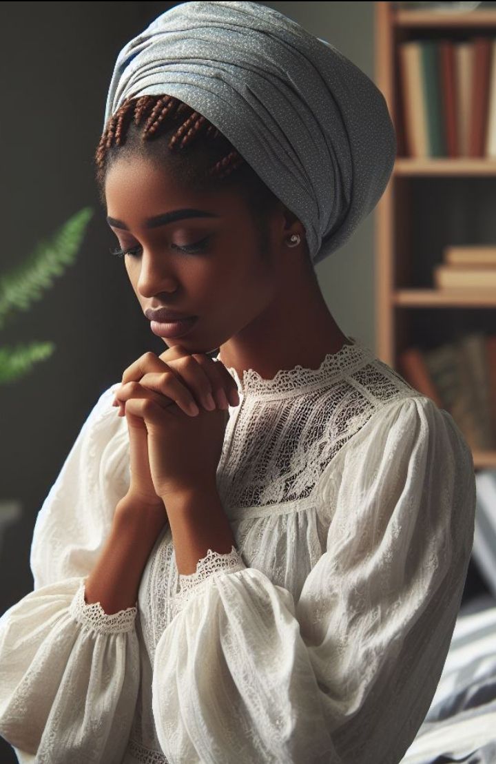 A woman kneeling in prayer in a quiet room, starting her day with faith and reflection.