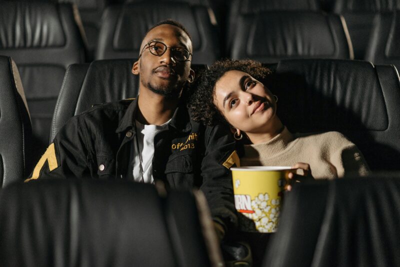 Happy couple spending time together in the cinemas — example of date ideas for Christian couple.