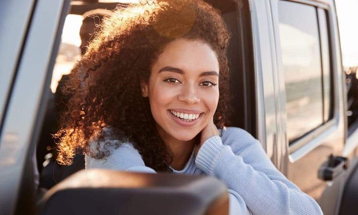 A woman pausing in quiet reflection, symbolizing finding God in everyday moments