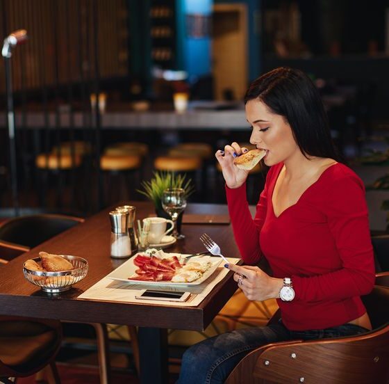 Woman enjoying a solo date at a café, embracing self-love and confidence