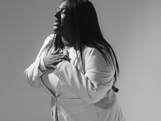 Christian artist singing on stage as their song rises on the Billboard Hot 100 chart.