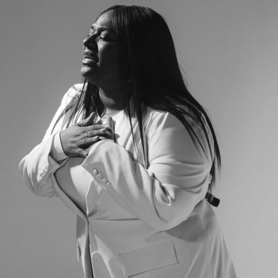 Christian artist singing on stage as their song rises on the Billboard Hot 100 chart.