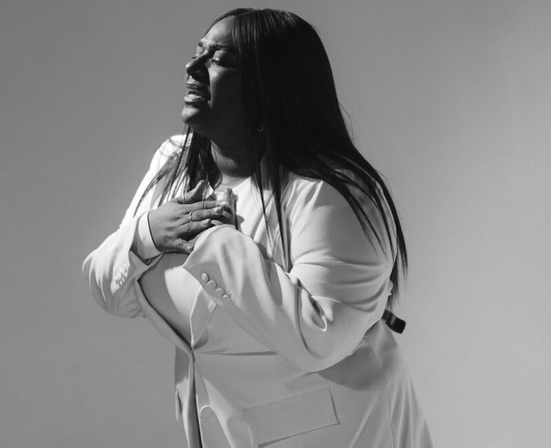 Christian artist singing on stage as their song rises on the Billboard Hot 100 chart.