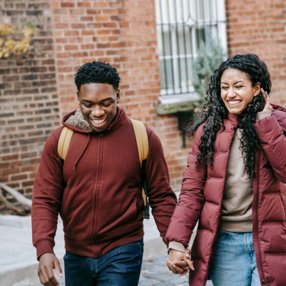 Couple laughing together while sharing a sweet moment, representing love languages in everyday relationships.
