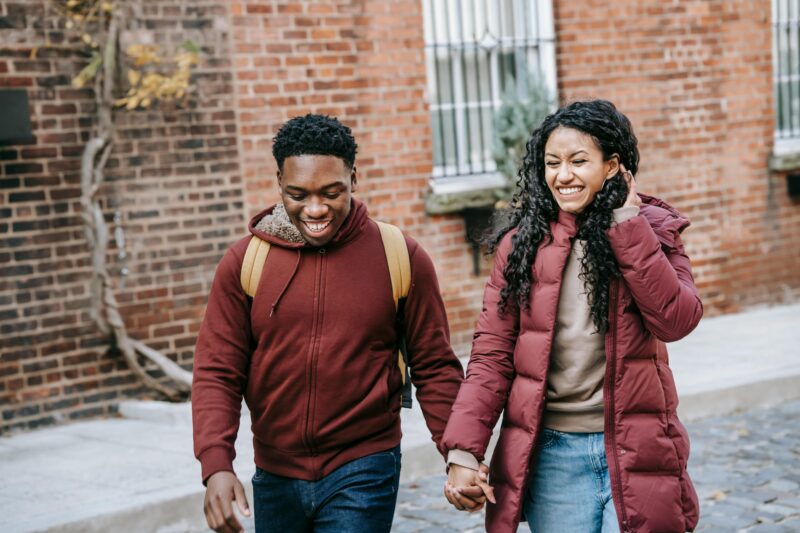Couple laughing together while sharing a sweet moment, representing love languages in everyday relationships.