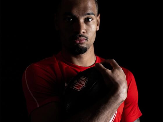 Emeka Egbuka smiling on the football field, Nigerian-American NFL player
