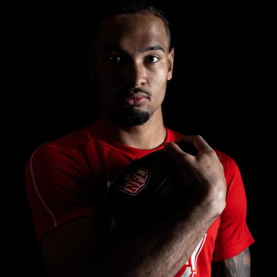 Emeka Egbuka smiling on the football field, Nigerian-American NFL player