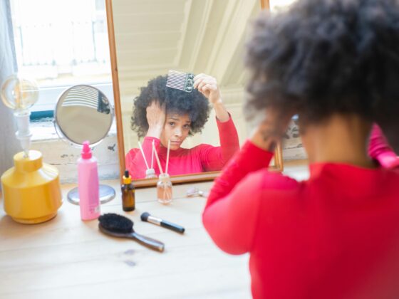 Woman styling her natural and relaxed hair, which is better?