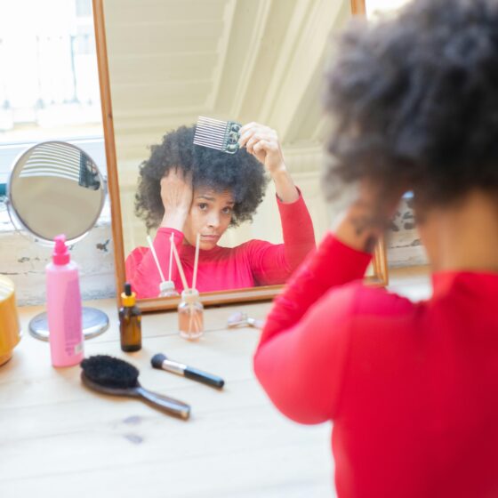 Woman styling her natural and relaxed hair, which is better?
